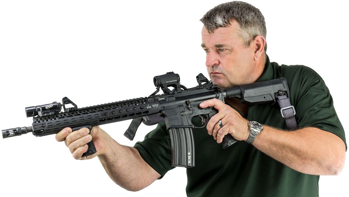 Larry Vickers with a BCM Carbine fitted with an Aimpoint and a pair of Scalarworks Peak Iron sights.